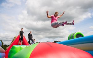 Flying through the air on The Labyrinth Challenge inflatable course